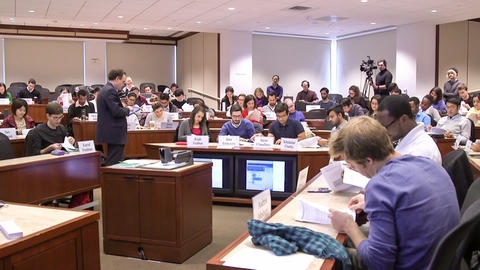 Students flipping through handouts