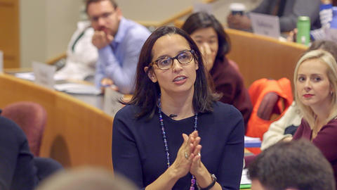 Close up of Professor Battilana listening with her hands together.