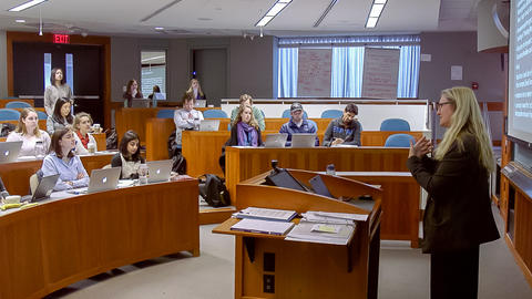 Side shot of Professor Grotzer at the front of the classroom and students listening.