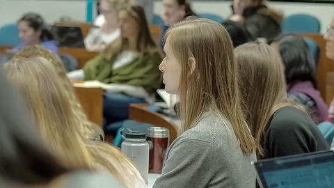 Close up of graduate student listening to Professor Grotzer's lecture.