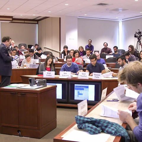 Students flipping through handouts