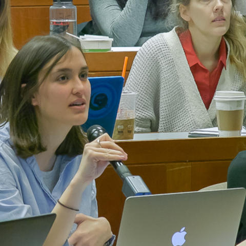 Close up of student with microphone responding to Professor Grotzer.